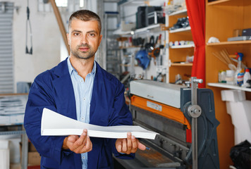 portrait of a working man at printer studio