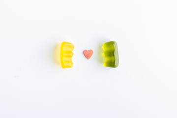 romantic gummy bears with a heart in the center on white background
