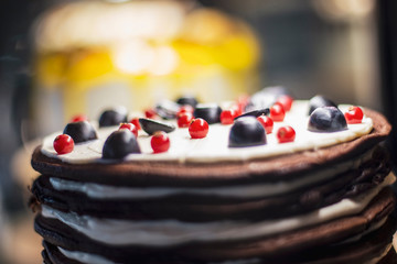 A view of a very appetizing and bright cake which is found in a confectioner's refrigerator-showcase in a cafe. selective focus, noise effect