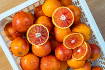 fresh red oranges in plastic crate top view b