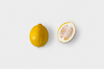 Ripe whole yellow Lemon citrus fruit with lemon fruit half isolated on white background with clipping path.High resolution photo.Top view.