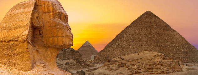 Sphinx against the backdrop of the great Egyptian pyramids. Africa, Giza Plateau.	