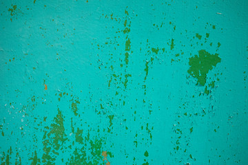 Green wall fragment with scratches and cracks 