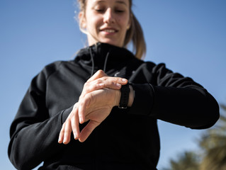 blondie woman wearing sport wear looking her watch