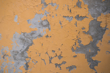 Yellow wall fragment with scratches and cracks 