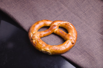 Shaped bread on the black tray on fabric