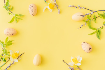 Naklejka na ściany i meble Flat lay easter composition with yellow daffodils and eggs on a yellow background