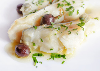Cod cooked in white with addition of olives and capers.