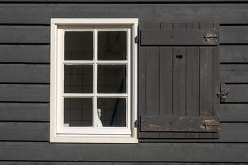 Fototapeta na wymiar Black wall with white window frame