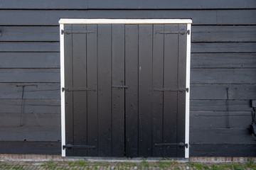 Abstract old storehouse with closed wood door