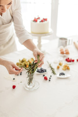 housewife using gorgeous greenery while preparing cake. close up cropped photo. the art of cooking