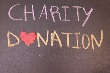 Charity Donation handwriting with colorful chalk and heart symbol instead of O
