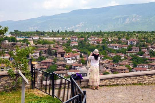 a tourist woman is taking Safranbolu town photos