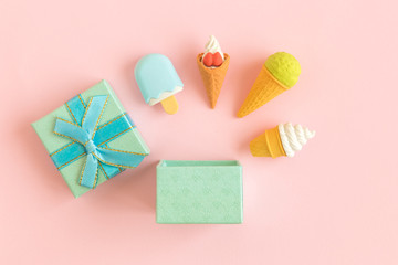 Flat lay of gift box and ice cream miniatures abstract.