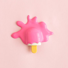 Flat lay of small melting rose ice cream abstract.