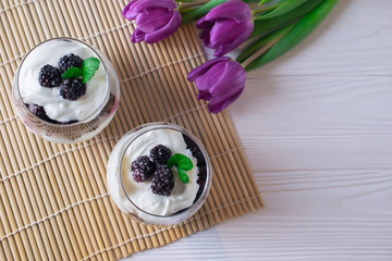 Fototapeta na wymiar Healthy organic breakfast in a glass with greek yogurt and berries, overhead, top view, flat lay