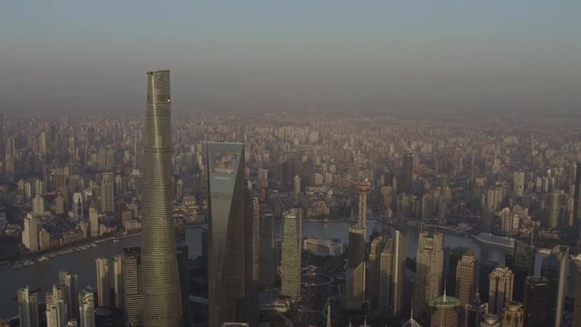 Shanghai China Aerial v81 Panning birdseye of sunrise cityscape with Pudong waterfront buildings in foreground - October 2018