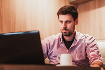 Young man working at home on his laptop