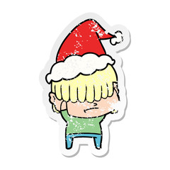 distressed sticker cartoon of a boy with untidy hair wearing santa hat