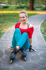 Fototapeta premium Girl on the rollers have fun in city summer park, enjoying healthy lifestile