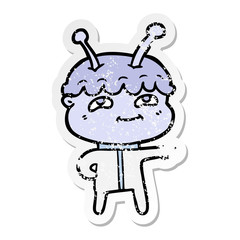 distressed sticker of a friendly cartoon spaceman pointing