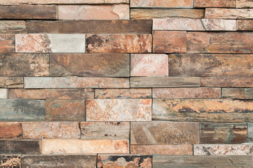 Grunge brown stone wall tiles texture. Wall panel natural brown,orange stone dirty,dust with pattern for architecture and interior design or abstract background.