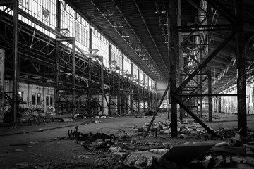 abandoned factory, old dirty factory hall, black and white photo, steel construction