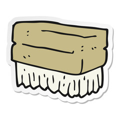 sticker of a cartoon scrubbing brush