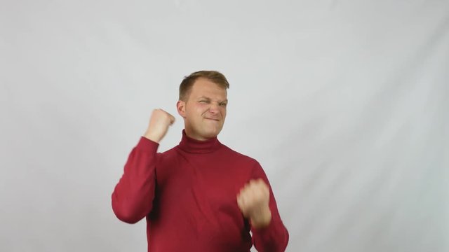 Young handsome man in red sweater posing for the camera