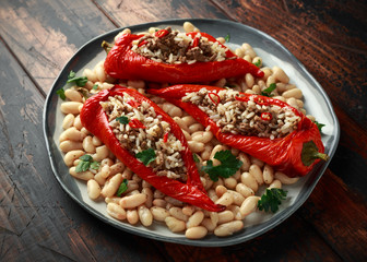 Stuffed pointed bell peppers with mince and basmati rice served with cannellini beans and chilli