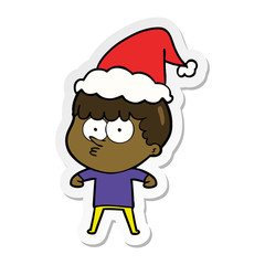 sticker cartoon of a curious boy wearing santa hat