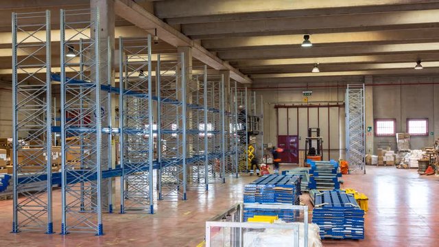 timelapse of industrial shelving assembly, workers at work in a warehouse of an Italian company