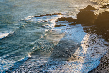 Sunset view of the Pacific Ocean waves at Nugget Point 