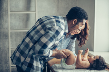happy couple singing songs to their adorable little kid, close up side view photo