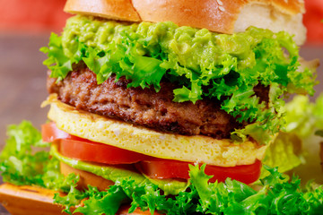 Cheeseburger with lettuce, tomato and pickles cooked at home