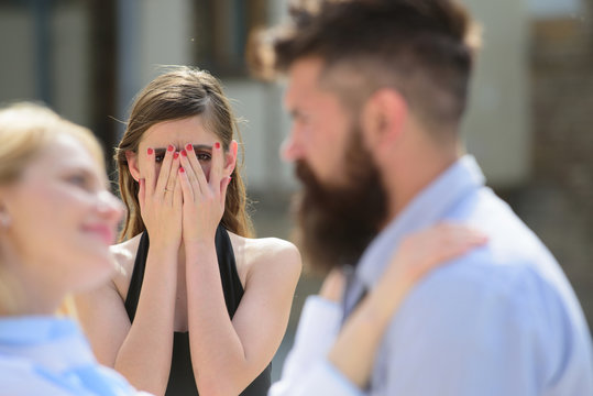 Possessive and jealous. Romantic couple of man and woman dating. Jealous girl look at couple in love on street. Bearded man cheating his woman with another girlfriend. Unhappy woman feeling jealous