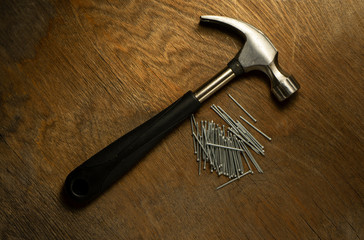 hammer with nails on wood background