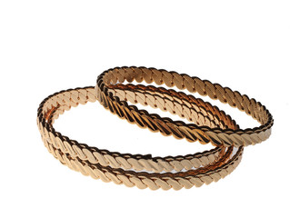 four golden bracelets on white background 