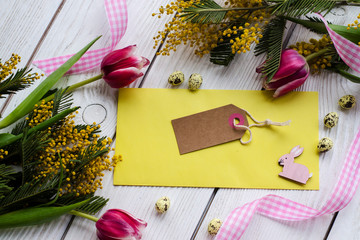 Easter egg and spring flowers on a wooden background . - Image