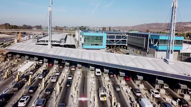 2018 - rising aerial over the San Ysidro Tijuana US Mexico border crossing with cars lined up for miles.