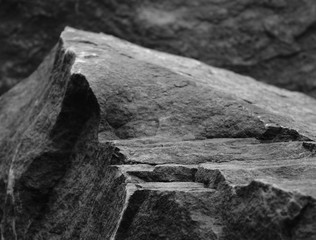 A Foreground Rock Step, Showing the Rough Texture of the Mineral Leading up to a Blurred Stone Peak.