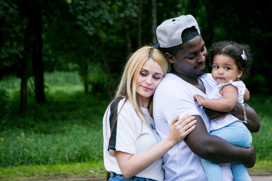 Happy Diverse Family With Daughter At Park. Beautiful Diverse Family