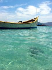 Boat on emerald clear water 