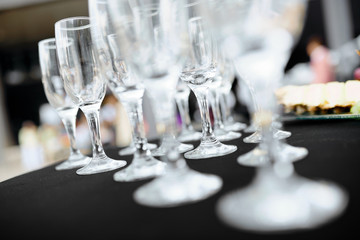 empty wine glasses on a white tablecloth on a table