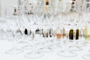 empty wine glasses on a white tablecloth on a table