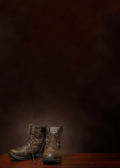 Old Work Boots On Brown Background With Copy Space Vertical