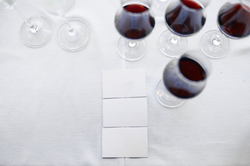 mockups on a white tablecloth with wine glasses