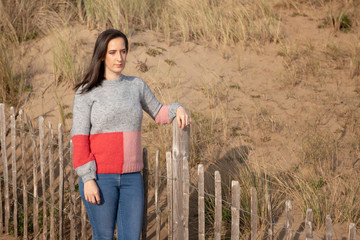 Young woman resting on fence outdoors 