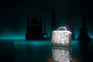 stack of traveling luggage in airport terminal and passenger plane flying over sky
