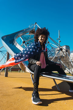 black woman with afro hair and an american flag celebrating the independence day of USA